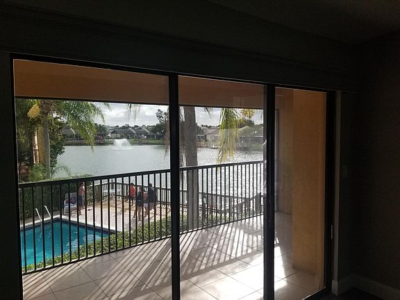 View from balcony has pool and lake views. End unit. Great privacy