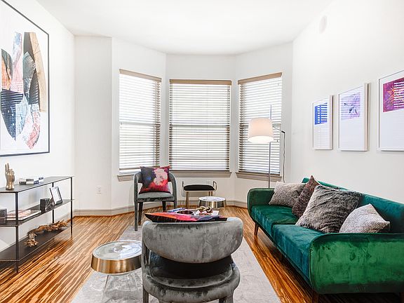 Griffis Uptown apartment living room with wood style flooring.