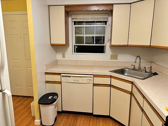 Kitchen sink , counter top with plenty of cabinetry; dishwasher.