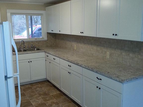 Kitchen with new counter, cabinets, sink and back splash