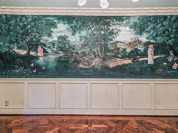 Mural in dining room provides a lovely background to a heavenly meal. Custom molding found throughout the house provides additional elgance!