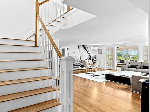 Stairs to the second floor and open floor plan of the living area