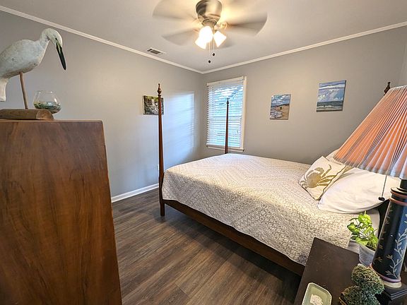 Bedroom 1 is bright and inviting. Queen bed, original art and a closet.