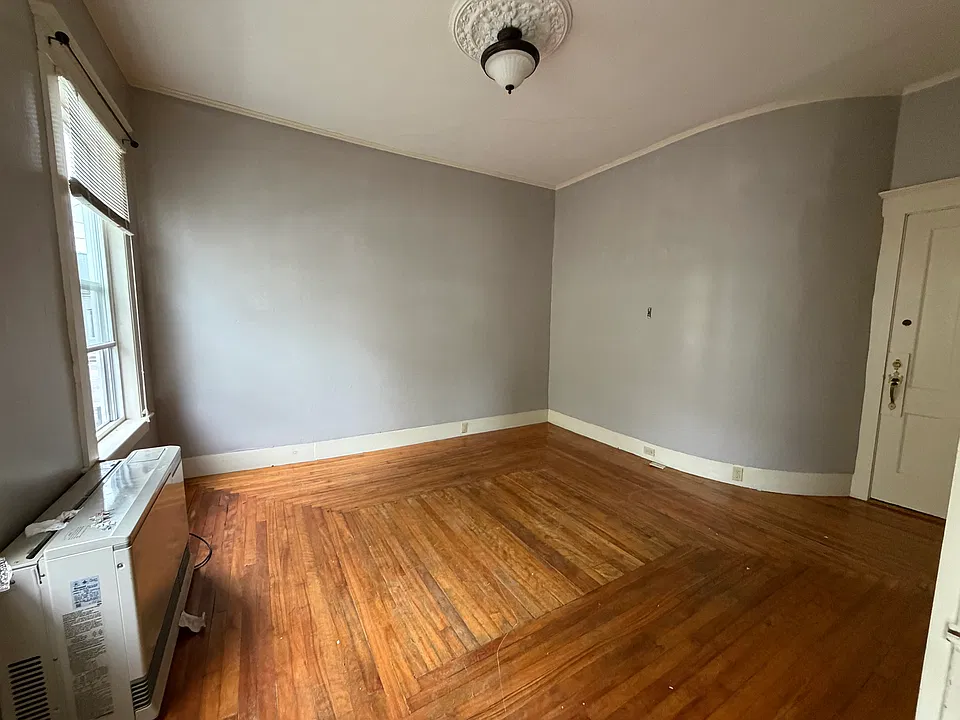 Nice living room with 2 large windows that let in ample light.
