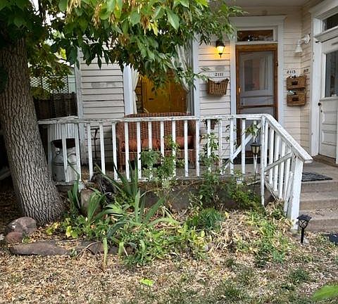 Front porch used by this apt. Each apt. has its' own private porch. This apt. has a porch on the front facing the street and Flatirons AND a back porch facing the large, peaceful backyard.
