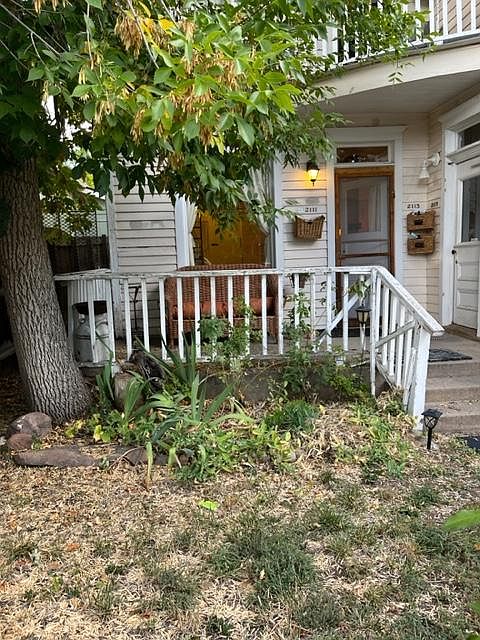 Front porch used by this apt. Each apt. has its' own private porch. This apt. has a porch on the front facing the street and Flatirons AND a back porch facing the large, peaceful backyard.