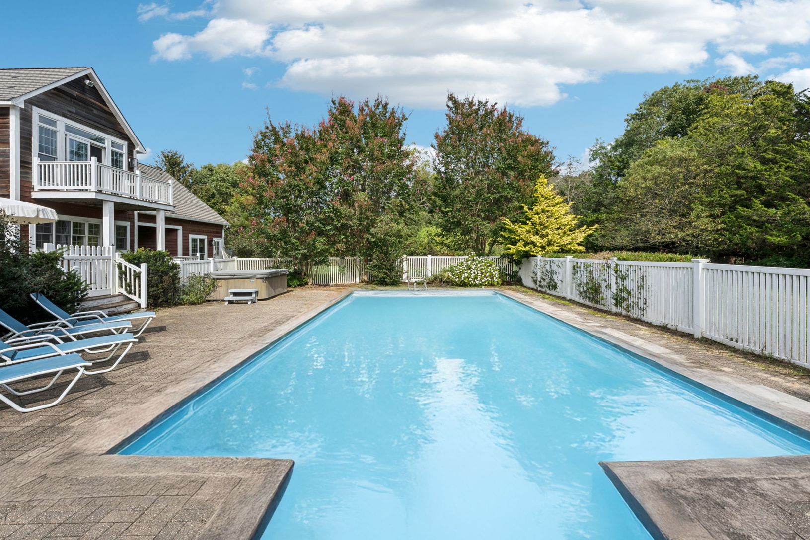 A captivating view reveals the swimming pool, sunlit patio, and spa.