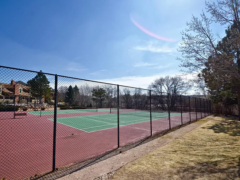 Two tennis courts, open green areas, access to trails.