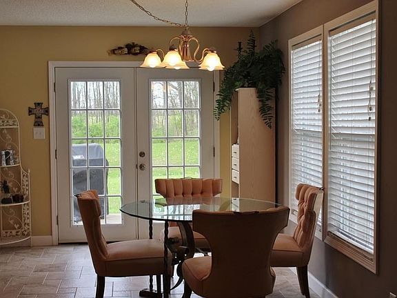 Open dining area with nice overhead lighting. Ceramic tile floor and full view rear atrium door.