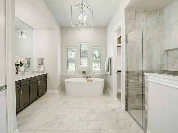 Staged master bathroom with a walk-in shower and soaking tub.