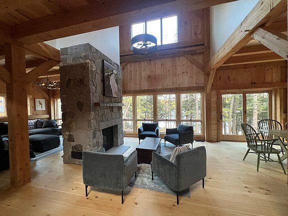 Looking toward the water, with main floor living room on the left and two-sided fireplace.