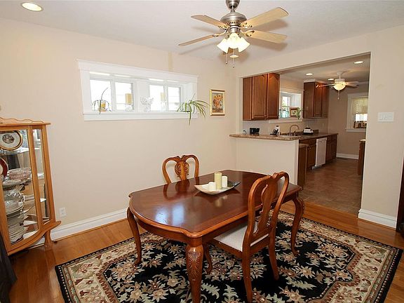 Spacious Dining Room with bar leading into the beautiful kitchen...lots of newer windows letting in natural lighting from all sides of the rooms.