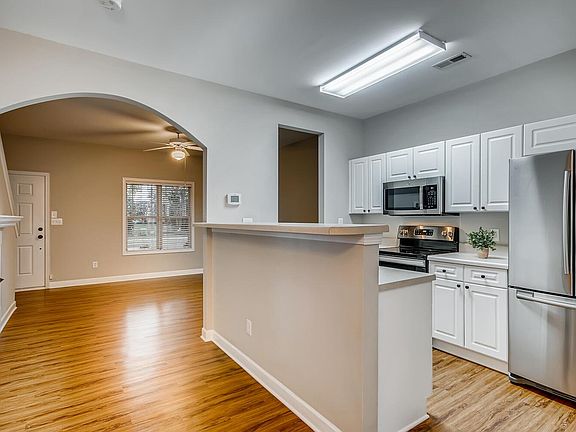 Light and bright kitchen has stainless appliances.