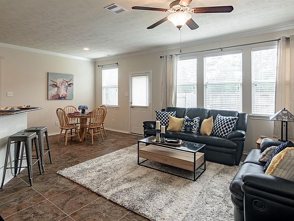 Large family room with wall of windows makes this home light and bright.