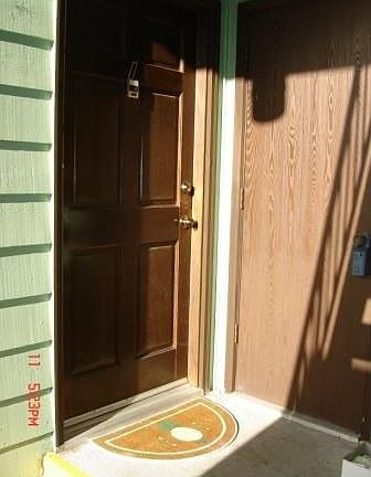 Front door with 1 of 2 storage closets