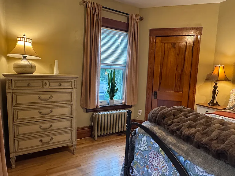 These next photos are of the same back bedroom but dressed in more spring like colors than the prior photos. The door in this photo is to the bedroom closet.