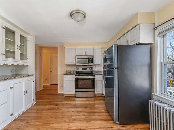 Kitchen has NEW white cabinets, granite counters, new ss refrigerator, ss stove and microwave