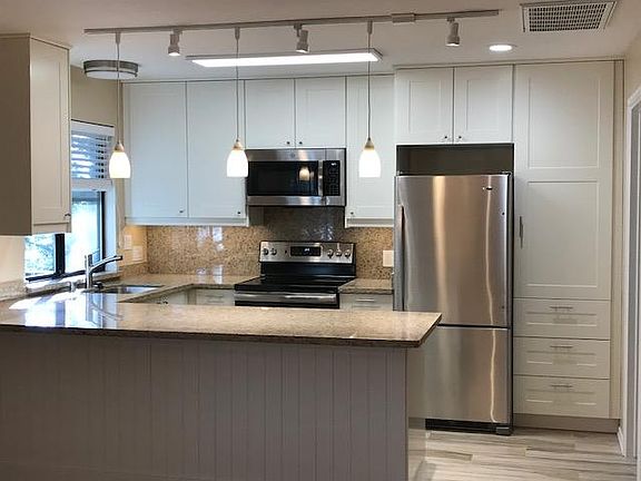 Kitchen with new stainless appliances.