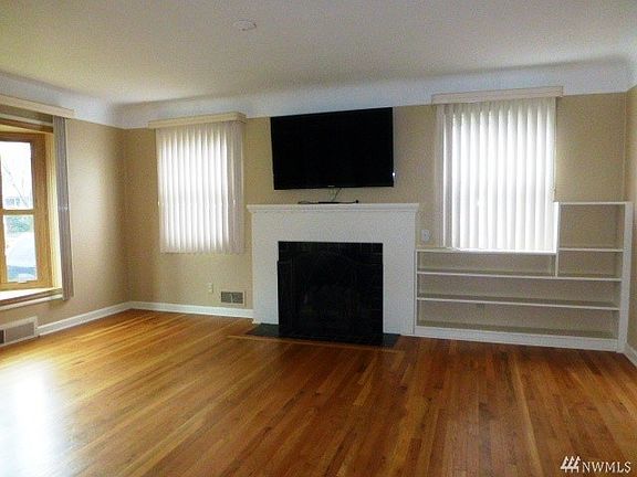 Built in shelves hardwood floors in the Living Room, with a wood burning fireplace to warm those chilly nights!