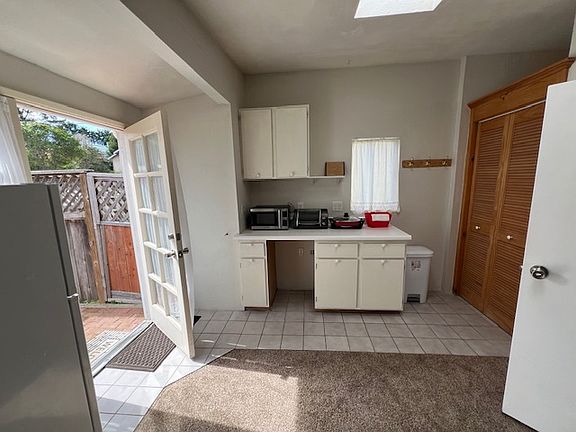 From bedroom area, looking towards kitchen area and front door