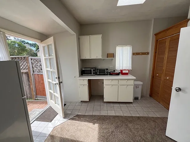 From bedroom area, looking towards kitchen area and front door