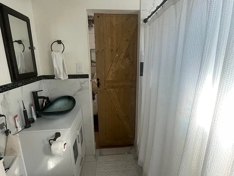 Bathroom has sliding barn door to each bedroom