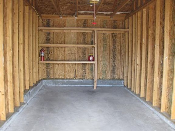 one car spacious garage with shelving