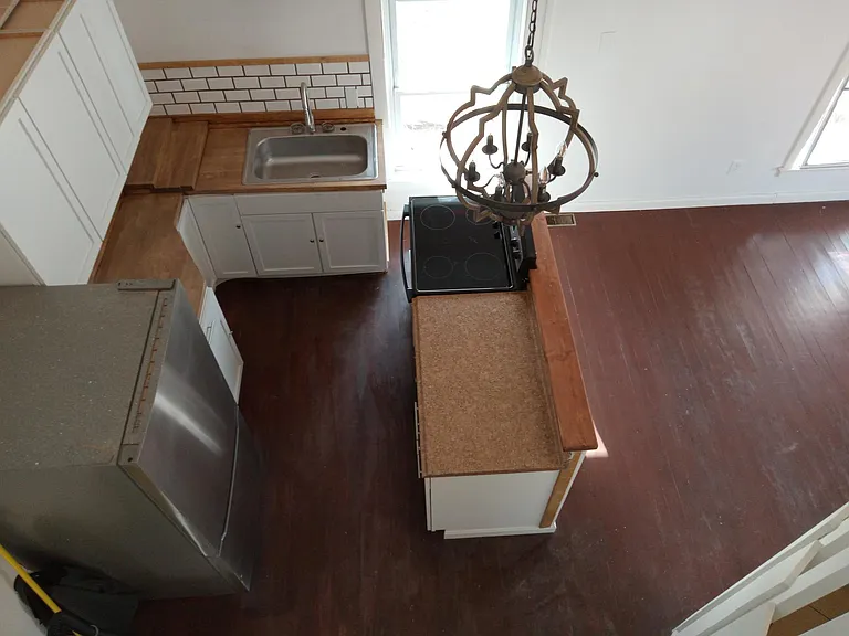 Looking down from the loft. Granet counter top next to stove