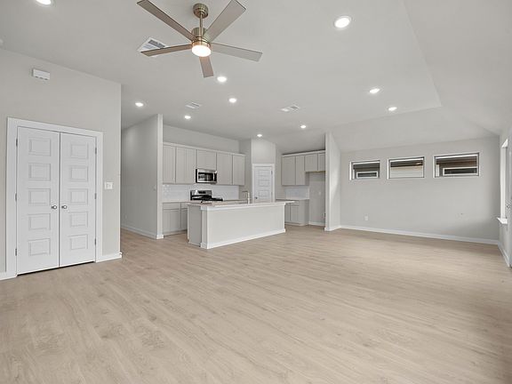 Kitchen in the Brazos home plan by Trophy Signature Homes - REPRESENTATIVE PHOTO