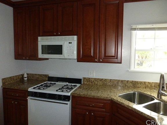 Very inviting Kitchen. Cherry Cabinets. Granite counters. Stove. Microwave. The drawers are the kind that don't slam shut. Lots of detail to this kitchen