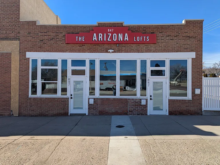 Storefront exterior with apartment entrance on right