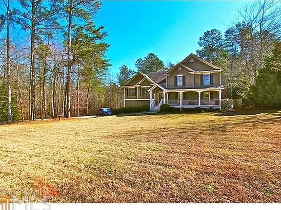 Inviting front porch overlooks a level front yard. Deliciously private.