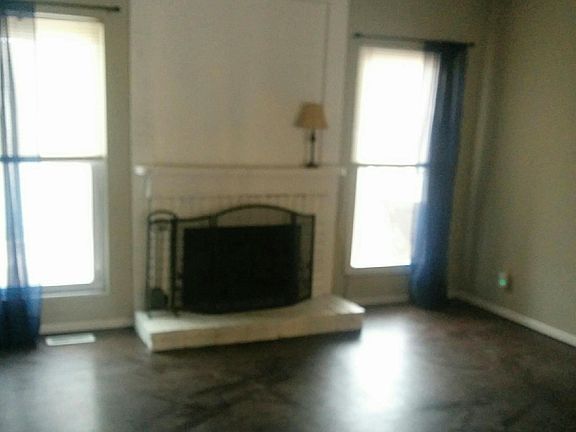 Living Room-- Wood Burning Fireplace-- Laminate flooring