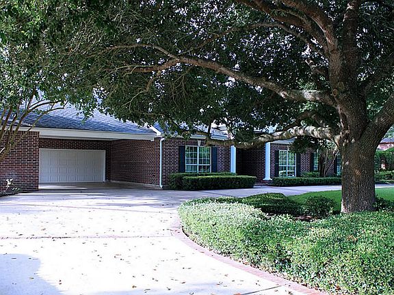 Notice the conveniently wide circular drive and mature landscaping.