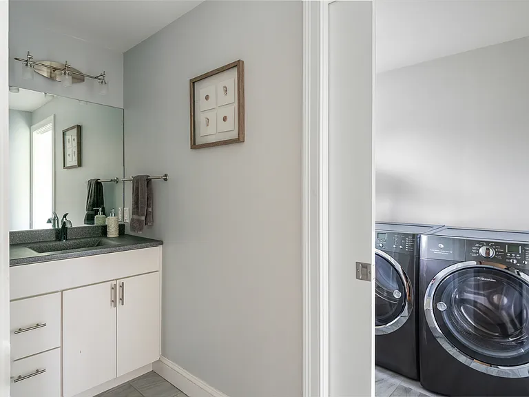 the second floor bathroom with the adjacent laundry room
