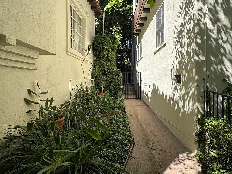 Side walkway - private gated walkway with lush landscaping.