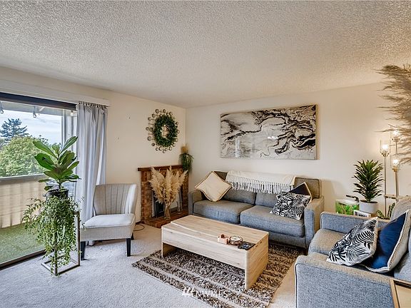 living room with a balcony for outdoor enjoyment, while watching the sunrise or set!