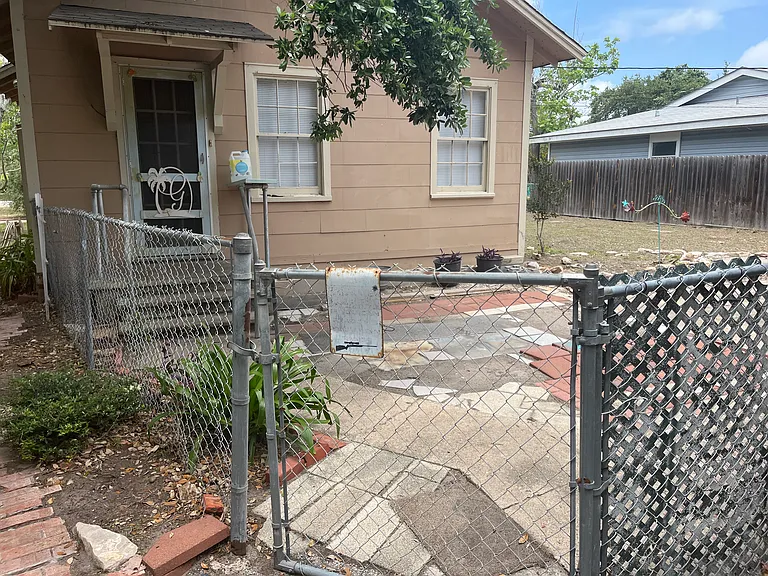 smaller fenced and gated area at back of house