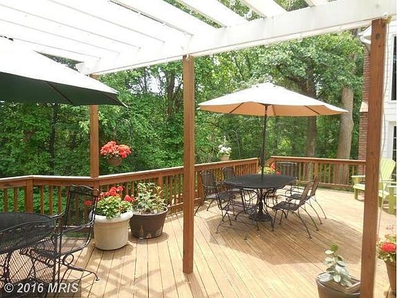 Deck overlooks private wooded backyard
