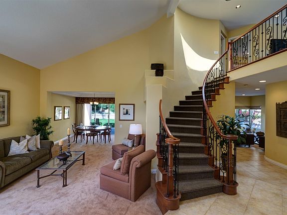 A formal entry with elegant wrought iron stairway greet all who enter.