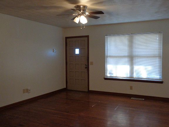 Living room. New blind and updated ceiling fan. Hardwood floor.