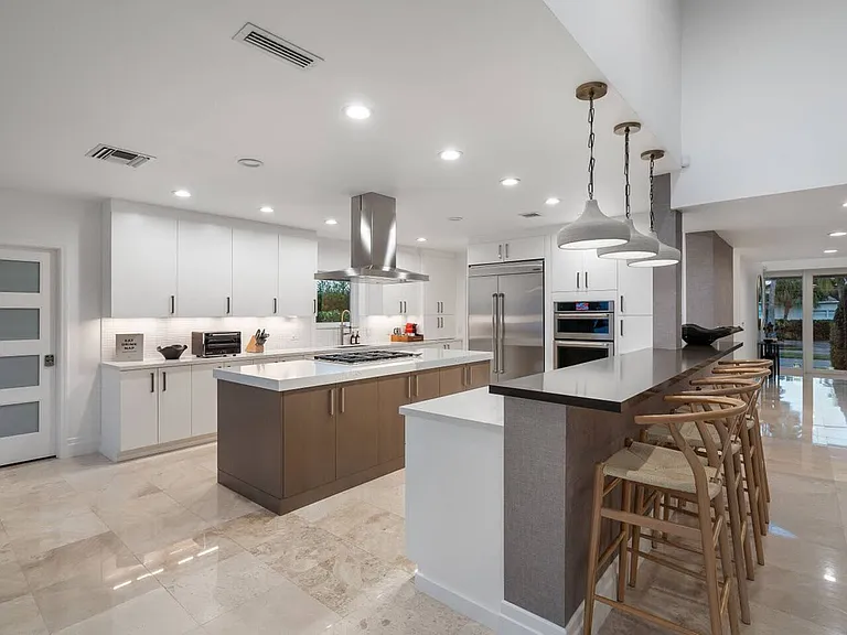 A spacious kitchen, featuring high-end appliances and a sleek island with bar seating for casual meals.