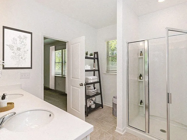 Bathroom with double vanity, and walk-in shower.