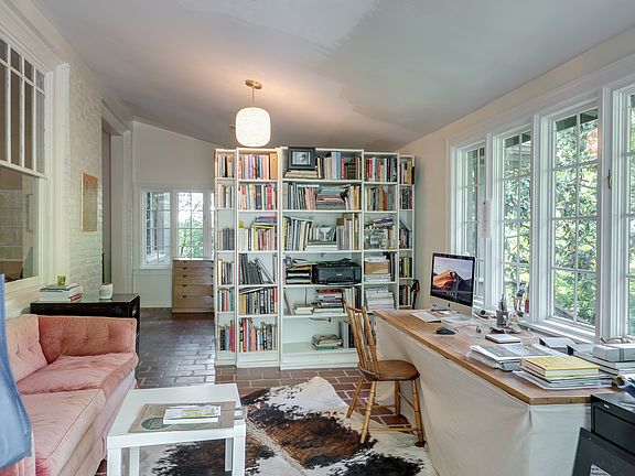 Entry Area, with plenty of room for office or den. View of quiet front yard. Accesses second outdoor patio. Book case is not built in.