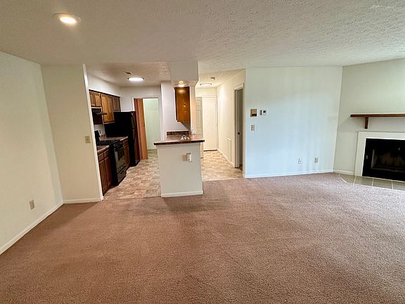 Dining room area on left, kitchen straight ahead, hallway to entry and living room on right