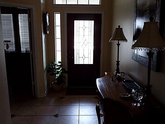 The beautiful leaded glass front door opens to the tiled foyer of your new home.