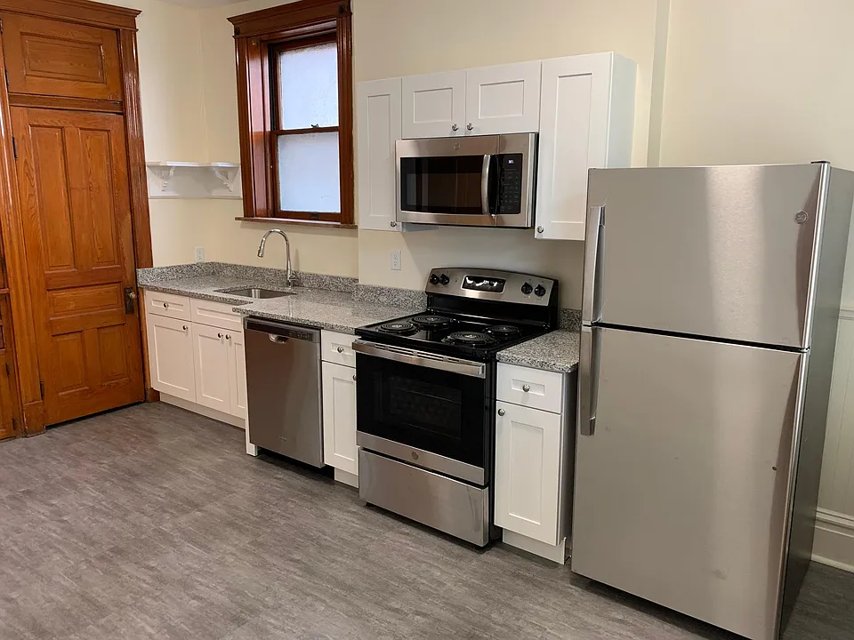 New kitchen with granite countertops and stainless steel appliances.