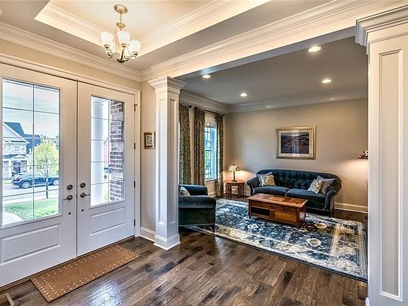 Through the double front doors one is greeted by gorgeous dark wood flooring that spans the first floor.