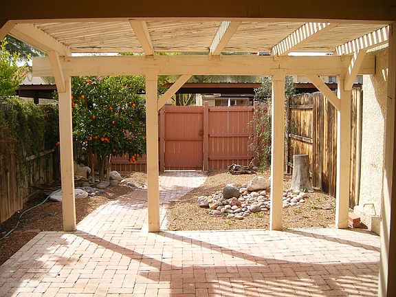 Looking out the back door to your patio- the gate leads 2 covered prking slots