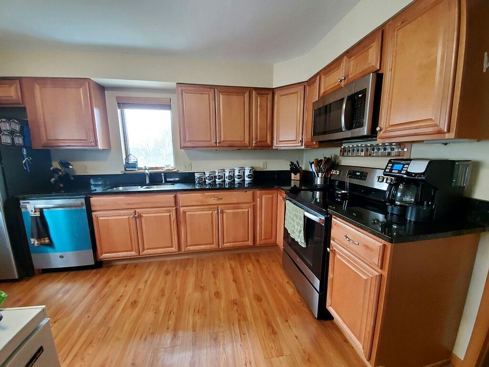 kitchen with lots of natural light, granite countertops, and stainless steel appliances.